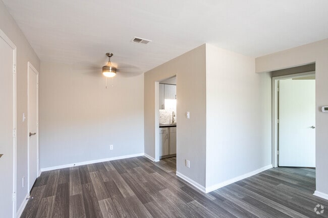 (R) RENOVATED THE FLOWERING DOGWOOD 1BR, 1BA - 700 SF - Living Room and Dining Area - Woodbridge Place Apartments