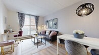 Located at 101 Boul Sacré-Coeur in Gatineau, Quebec, this well-appointed one-bedroom, one-bathroom unit offers a smart and efficient layout across a single floor. Light wood laminate flooring flows throughout, creating a cohesive and bright interior.

A welcoming hallway with built-in hooks leads into the heart of the unit. The combined living and dining area is the standout space, featuring a large sliding window that floods the room with natural light and offers views of the surrounding neighbourhood. The open layout comfortably accommodates both a seating area and a dining table.

The kitchen is tucked adjacent to the living space and features white cabinetry with ample storage, a countertop with an undermount sink, and white appliances including a full-size refrigerator — all set against the same light wood flooring.

The bedroom is a calm and comfortable retreat, with a window providing natural light, space for a full-size bed, and a dedicated area suitable for a work desk. Neutral tones and clean lines give the room a relaxed ambiance.

The bathroom is functional and tidy, featuring a vanity with storage, a toilet, and a bathtub with a shower curtain enclosure, accented by warm-toned wall tiles.