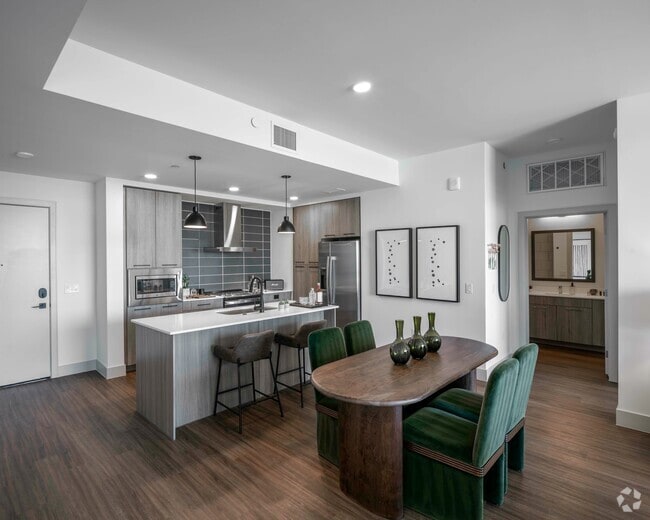 A refined kitchen and dining space that blends natural tones with bold accents. - Mica RiNo