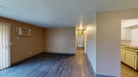 Located at 3814 Pine Terrace Blvd in Kalamazoo, Michigan, this single-floor, 2-bedroom, 2-bathroom residence offers a practical and comfortable layout. The living and dining areas are finished with dark hardwood-style flooring and warm neutral-toned walls, creating an inviting atmosphere. A sliding glass door with vertical blinds fills the living space with natural light and provides access to outdoor views. The galley-style kitchen features white cabinetry, light laminate countertops, a double stainless steel sink, and includes a range, refrigerator, and dishwasher, with an adjacent pantry offering additional storage. A central hallway connects the main living areas to both bedrooms and bathrooms. Each bedroom is carpeted and includes a built-in closet with bifold doors. The primary bedroom is notably spacious and features direct access to one of the two bathrooms. The full bathroom includes a tiled tub-shower combination with a vanity and wood-style flooring, while the second bathroom offers a single vanity with a large mirror and bright overhead lighting. With four closets throughout, storage is plentiful. The textured ceilings and clean, neutral finishes give this residence a move-in-ready feel.