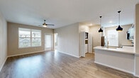 Located at 305 W FM 1187 in Crowley, TX, this single-story residence offers a thoughtfully designed one-bedroom, one-bathroom layout with a practical and modern feel. The open-concept living and dining area is anchored by warm wood-look luxury vinyl plank flooring, neutral wall tones, and a ceiling fan — creating a bright, airy atmosphere enhanced by natural light from multiple windows. Access to two patios extends the living space outdoors.

The kitchen is a standout feature, equipped with dark espresso cabinetry, white quartz countertops, a subway tile backsplash, stainless steel appliances — including a range, microwave, and dishwasher — and a peninsula with pendant lighting that doubles as a breakfast bar. A louvered-door utility closet provides convenient in-unit laundry access.

The bedroom offers plush carpeting, a ceiling fan, and a generous window with neighborhood views. An adjoining closet provides ample storage. The bathroom features a dark-cabinetry vanity with a white countertop, a tiled tub-shower combination, and wood-look flooring. A hallway connects the private and shared spaces efficiently, completing a cohesive and functional floor plan ideal for comfortable single-occupant living.