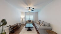 Located in Oxford, Mississippi, this single-story, 3-bedroom, 3-bathroom home offers a practical and comfortable layout designed for everyday living. The living room serves as the heart of the home, featuring rich wood-look flooring, neutral-toned walls, and a ceiling fan with light fixture. Natural light filters in through blinds-fitted windows, creating a warm and inviting atmosphere. The open kitchen is equipped with rich walnut-toned cabinetry, stainless steel appliances including a refrigerator, over-the-range microwave, and electric range, along with a double-basin sink and light countertops. A peninsula counter separates the kitchen from the dining area, which accommodates a full dining set. Each of the three bedrooms provides a comfortable retreat, with wood-look flooring, ceiling fans, and windows that allow natural light. The bedrooms include closets with built-in shelving for ample storage. The three bathrooms are consistently finished with wood-toned vanities, white countertops, and shower-tub combinations. Throughout the home, the consistent use of wood-look flooring and neutral wall tones creates a cohesive, clean aesthetic well-suited for comfortable residential living.