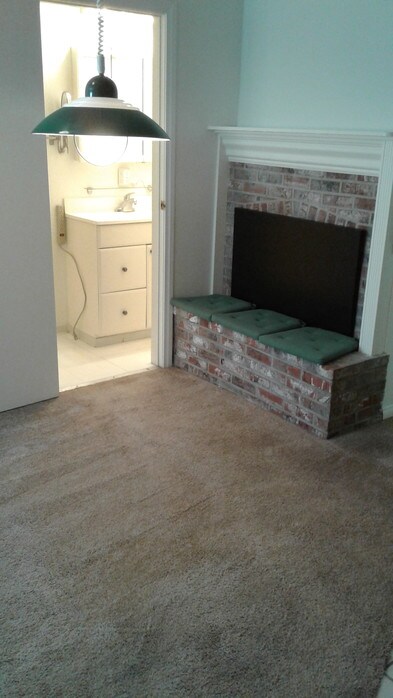 Living room with fire place and bathroom view - 1054 W 23rd St