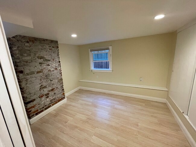 Bedroom with charming brick accent wall - 1534 Benton St