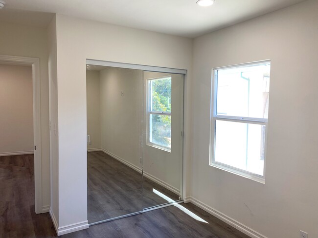 bedroom with mirror closet doors - 12230 W Magnolia Blvd