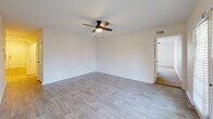 Located at 2426 Thoroughbred Dr in Bowling Green, Kentucky, this single-floor, two-bedroom, two-bathroom home offers a well-designed layout with practical finishes throughout. The kitchen serves as a central hub, featuring cream-toned cabinetry with modern black hardware, white countertops, stainless steel appliances including a refrigerator, microwave, and range, and light wood-look tile flooring. A peninsula with a pendant light adds a functional dining or prep area, while a pantry closet provides ample storage. The living and kitchen areas share the same light, airy flooring, creating a cohesive open feel. Both bedrooms are carpeted and fitted with ceiling fans, offering a comfortable and quiet retreat. The primary bedroom includes a closet, and windows throughout bring in natural light with views of the surrounding neighborhood. The two bathrooms are consistent in design, each featuring wood-look tile flooring, a tub-shower combo with white subway tile accented by a bold black tile border, a vanity with cabinetry, and a wall-mounted medicine cabinet. A dedicated laundry room with washer and dryer hookups adds everyday convenience. The home's clean, neutral palette and consistent finishes create a bright, move-in-ready atmosphere throughout.