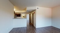 Located at 3141 Willow Creek Rd in Prescott, Arizona, this single-story 1-bedroom, 1-bathroom unit offers a clean, modern aesthetic throughout. Wood-style flooring runs consistently across the living areas, bedroom, and kitchen, lending a cohesive and contemporary feel to the space.

The open-concept living and dining area is bright and welcoming, with a large window framing views of the surrounding Prescott landscape, allowing natural light to fill the room. A second window in the bedroom further enhances the airy atmosphere and provides additional outdoor views.

The kitchen is efficiently designed with dark cabinetry, granite-style countertops, and a full suite of stainless steel appliances, including a refrigerator, dishwasher, range, and microwave. A breakfast bar peninsula connects the kitchen to the living area, making it ideal for casual dining or entertaining. In-unit laundry hookups are visible, adding everyday convenience.

The bathroom is neatly finished with matching dark cabinetry, a granite-style vanity countertop, a large mirror, and a combination tub and shower. Wood-style flooring continues into this space, maintaining the consistent design language found throughout the unit.

Overall, this unit presents a practical and polished living space with modern finishes, ample natural light, and a well-considered layout suited for comfortable day-to-day living in Prescott, AZ.