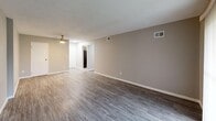 This 540 square foot apartment in Highland Heights, KY offers a thoughtfully designed living space with modern amenities. The single-story layout encompasses one bedroom, one bathroom, a living room, kitchen, and hallway. The primary bedroom, measuring 120 square feet, provides a comfortable retreat.

Throughout the apartment, wood-look vinyl flooring creates a cohesive and contemporary aesthetic. The neutral gray walls enhance the sense of space and light, complemented by white trim and doors. The living area features an open concept design, allowing for versatile furniture arrangements and easy flow between spaces.

The kitchen boasts crisp white cabinetry, contrasting nicely with granite-look countertops. Stainless steel appliances, including a range and dishwasher, add a modern touch. The bathroom, while compact, offers a clean and functional design with a white vanity and mirror cabinet.

Large windows in the living area and bedroom invite natural light, creating a bright and airy atmosphere. The apartment's layout maximizes the use of space, making it an ideal choice for those seeking a low-maintenance yet stylish living environment. The property's location on Hidden Valley Dr provides easy access to local amenities while maintaining a sense of privacy.