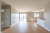 Located at 565 Talbot St in London, Ontario, this 2-bedroom, 1-bathroom unit offers a clean, functional layout across a single floor. Light-toned hardwood flooring runs throughout the entire space, lending a bright and cohesive feel to every room.

The kitchen is designed as a galley-style space, featuring white cabinetry, grey countertops, a stainless steel refrigerator, and additional appliances including a stove and microwave. It connects conveniently to the entry corridor and the main living area.

The combined living room opens to a private balcony through a large sliding glass door, providing generous natural light and an outdoor view of surrounding greenery. A secondary window further enhances ventilation and brightness in this area. Baseboard heating units are present throughout the unit.

Both bedrooms are well-proportioned with neutral grey walls, light hardwood floors, and white trim. The primary bedroom offers a comfortable footprint, while the second bedroom includes a window overlooking the exterior. Each room benefits from natural light and a clean, minimalist aesthetic.

The bathroom is finished in white, featuring a full soaker tub with shower, a toilet, and a mirrored vanity. The overall design of the unit is straightforward and practical, making it a well-suited space in a central London location.