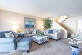 Located at 111 Lochaven Dr in Newport News, Virginia, this two-story home offers a thoughtfully designed layout with comfortable, functional spaces across both levels. The living room provides a welcoming gathering area with plush carpeting, ample natural light, and a staircase connecting to the upper floor. A separate sitting area adds flexibility, accented by large windows and vibrant décor. The dining area features windows that invite natural light and views of the outdoors, creating a bright and pleasant atmosphere for meals. The kitchen is well-equipped with dark espresso cabinetry, granite-style countertops, stainless steel appliances including a full-size refrigerator and dishwasher, and durable wood-look flooring. Multiple bedrooms are spread across the home, each featuring warm hardwood floors, ample closet space, and windows that bring in natural light. The primary bedroom includes a spacious sliding-door closet. The full bathroom impresses with dark wood vanity cabinetry, granite countertops, a tub-shower combination, and wood-look flooring. A secondary half-bath offers additional convenience with a matching dark vanity and clean finishes. This home combines practical design with warm, inviting interiors throughout.