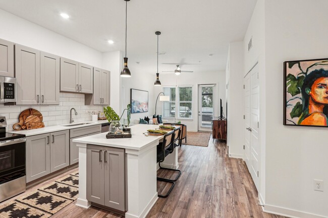 Welcome to your new home. Enjoy you new modern kitchen with a white island and wooden floorsw - Tapestry University Park