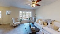 Located at 155 Champion Ave in Webster, NY, this two-floor home offers a welcoming and functional layout across both levels. The living room is a standout space, centered around a large bay window that floods the room with natural light and offers pleasant views of the surrounding neighborhood. Light hardwood-style flooring, a ceiling fan, and neutral warm tones create an inviting atmosphere. Adjacent to the living room is a dedicated dining area with exterior door access and window views, providing a comfortable space for everyday meals. The kitchen is well-equipped with rich dark cabinetry, light countertops, and a full suite of stainless steel appliances including a side-by-side refrigerator, electric range, and over-the-range microwave. The bedrooms feature plush gray carpeting, ceiling fans, and generous closet space, including double closet doors in the primary bedroom. The bathrooms are clean and functional — one features dark slate-style tile flooring with a tub-shower combination, while the other offers light wood-style flooring and a dark vanity with a white countertop. Throughout the home, neutral wall tones and consistent finishes create a cohesive, move-in-ready feel suited for comfortable everyday living.