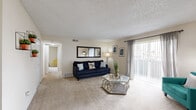 Located at 809 Dillon Way in Aurora, Colorado, this three-bedroom, one-bathroom residence offers a practical and comfortable single-floor layout. The living room serves as the heart of the home, featuring plush wall-to-wall carpeting, a textured ceiling, and a large sliding glass door dressed with sheer curtains that floods the space with natural light and provides access to an outdoor area. The open and airy feel is complemented by neutral wall tones throughout.

Adjacent to the living room, the dining area features tile flooring and offers a dedicated space for meals and entertaining. The galley-style kitchen is efficiently designed with warm wood cabinetry, dark granite-style countertops, tile flooring, and a full suite of white appliances including a refrigerator, range, and dishwasher — maximizing every inch of space.

The primary bedroom is generously sized with soft carpeting, a sunlit window, and ample room for furnishings. The additional bedrooms are well-proportioned and include closets with built-in shelving and hanging rods for storage. The shared full bathroom features tile-surround tub and shower, a wood-toned vanity, and tile flooring. A hallway connects all rooms, contributing to a cohesive and efficient floor plan.