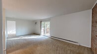 Located at 5500 Beechmont Ave in Cincinnati, Ohio, this one-bedroom, one-bathroom residence offers a well-organized single-floor layout with a practical and comfortable design. The spacious living room is carpeted and bathed in natural light, featuring a sliding glass door that opens directly onto a private balcony overlooking lush greenery — an inviting indoor-outdoor connection. Baseboard heating runs throughout the carpeted areas, ensuring consistent warmth, while a wall-mounted air conditioning unit provides cooling comfort in the living space. The kitchen is equipped with stainless steel appliances, including an electric range, over-the-range microwave, and refrigerator, complemented by warm wood cabinetry, granite-style countertops, and clean tile flooring. A ceiling fan adds airflow to the kitchen area. The generously sized bedroom features plush carpeting, a wide window with outdoor views, and access to two closets, providing ample storage. The bathroom includes a wood-toned vanity with a white countertop, a medicine cabinet mirror, and a shower. Clean white walls and neutral tones throughout the home create a bright, understated aesthetic that is easy to personalize.