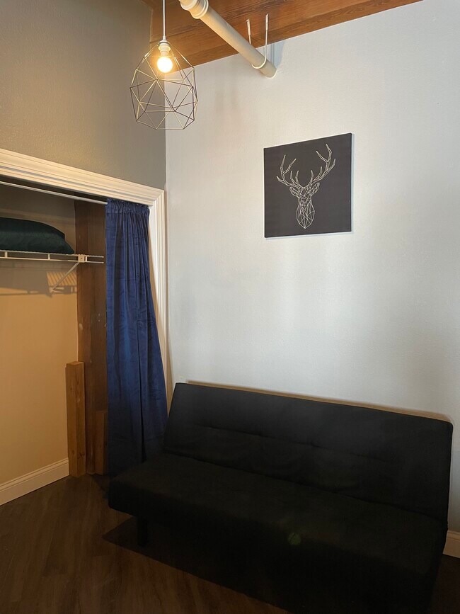 Raised bedroom area. The futon can be replaced with a twin or full-sized bed. - 308 W 8th St