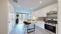 Located at 201 Munson Street in New Haven, CT, this modern 1-bedroom, 2-bathroom residence offers a thoughtfully designed open-concept layout with contemporary finishes throughout. The combined kitchen and living area serves as the heart of the home, featuring sleek white cabinetry, a gray tile backsplash, stainless steel appliances, and light wood-tone flooring. A freestanding island with bar seating provides additional dining and prep space, making the kitchen as functional as it is stylish. The living area flows seamlessly toward large floor-to-ceiling sliding glass doors that open to a private balcony, offering views of the surrounding neighborhood streetscape. Natural light fills the space generously through these expansive windows. The bedroom is a calm retreat, highlighted by a wide window with neighborhood views, neutral-toned walls, and durable flooring. Two bathrooms provide convenience and privacy — one features a floating wood-toned vanity with a white quartz countertop, marble-look tile flooring, and modern matte black fixtures, while the other includes a sleek walk-in shower with white tile surround and black-framed glass enclosure. A dedicated closet adds practical storage. Recessed lighting throughout and a clean, neutral palette contribute to the residence's modern, cohesive aesthetic.