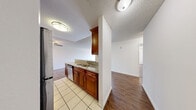 Located at 1538 N Vista St in the heart of Los Angeles, CA 90046, this one-bedroom, one-bathroom unit offers a practical and comfortable single-floor layout. The open-concept kitchen and living area serves as the central hub of the home, featuring rich, warm-toned wood cabinetry, granite countertops, and stainless steel appliances including a gas range and refrigerator. Light tile flooring in the kitchen transitions seamlessly into durable hardwood-style flooring that extends through the living area and bedroom. A ceiling fan in the living room adds to the comfort of the space, which also benefits from a sliding glass door that allows natural light to pour in. The spacious living room provides ample room for flexible furniture arrangements. The well-proportioned bedroom features a window with views of surrounding greenery, offering a bright and calm retreat. A dedicated closet adds practical storage. The bathroom is finished with tile flooring, a granite-topped vanity with wood cabinetry, and a full tub/shower combination with white subway tile surround. Textured ceilings are present throughout. This unit offers a clean, functional layout ideal for comfortable urban living in one of Los Angeles' vibrant neighborhoods.