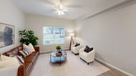 This contemporary apartment, located at 100 N Fifth St in Wylie, TX, offers 860 square feet of thoughtfully designed living space. The single-story layout includes two bedrooms, with the primary bedroom boasting a generous 180 square feet. The open-concept design seamlessly integrates the kitchen and living area, creating a spacious feel.

The kitchen is a standout feature, showcasing dark wood cabinetry, granite countertops, and stainless steel appliances, including a side-by-side refrigerator. A convenient breakfast bar with seating adds functionality to the space. The living area is bathed in natural light from large windows and features a ceiling fan for comfort.

The bathroom is modernly appointed with a granite-topped vanity, large mirror, and a combination tub-shower with sleek tiling. Both bedrooms offer ample space and natural light, with the primary bedroom featuring an en-suite bathroom.

Throughout the apartment, you'll find neutral-toned walls, wood-look flooring, and recessed lighting, creating a cohesive and contemporary aesthetic. The property's attention to detail extends to its furnishings, with stylish accents like white armchairs, a leather sofa, and carefully chosen decor pieces enhancing the overall ambiance.