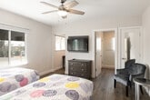 Located at 4821 W Century Blvd in Inglewood, California, this single-floor unit offers a clean, modern layout designed for comfortable living. The main room is a well-appointed sleeping area featuring two twin beds with upholstered wood-panel headboards, warm wood-look flooring, and a ceiling fan with integrated lighting. Large windows flood the room with natural light and offer views of the surrounding streetscape, while an in-unit climate control unit ensures year-round comfort. A cozy accent chair adds a relaxed seating option. The kitchen is efficiently designed with white shaker-style cabinetry, a classic white subway tile backsplash, light stone countertops, a stainless steel sink, and a full suite of white appliances including a gas range, over-the-range microwave, and refrigerator. A dining table with chairs provides a dedicated space for meals. The bathroom is finished with the same wood-look flooring and features a sleek, glass-enclosed walk-in shower with textured privacy glass panels, a toilet, and a vanity. The consistent use of light tones and durable finishes throughout creates a cohesive, contemporary aesthetic suited for both short-term and extended occupancy.