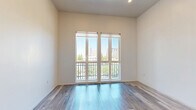 Located at 1026 17th St in downtown Sacramento, California, this efficiently designed unit offers a thoughtfully arranged single-floor layout that maximizes every square foot. The main living area features light-toned hardwood-style flooring and crisp white walls that create a bright, airy atmosphere. Elevated ceilings add a sense of openness, while a sliding glass door provides access to an outdoor balcony, inviting natural light deep into the space.

The kitchen is a standout feature, showcasing sleek, modern cabinetry in a textured gray finish paired with white quartz countertops. Stainless steel appliances — including a refrigerator, wall oven, induction cooktop, and dishwasher — deliver a fully equipped, contemporary cooking experience. Under-cabinet lighting enhances both functionality and ambiance.

The bathroom continues the modern aesthetic with large-format neutral floor tiles, a wall-mounted floating vanity with integrated drawers, a white countertop, and a frameless mirror. The clean, minimalist design gives the space a polished, hotel-like feel.

A dedicated closet provides organized storage, rounding out this well-appointed unit. With its contemporary finishes, efficient layout, and prime downtown Sacramento location, this space offers a refined urban living experience.