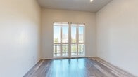 Located at 1026 17th St in downtown Sacramento, California, this efficiently designed unit offers a thoughtfully arranged single-floor layout that maximizes every square foot. The main living area features light-toned hardwood-style flooring and crisp white walls that create a bright, airy atmosphere. Elevated ceilings add a sense of openness, while a sliding glass door provides access to an outdoor balcony, inviting natural light deep into the space.

The kitchen is a standout feature, showcasing sleek, modern cabinetry in a textured gray finish paired with white quartz countertops. Stainless steel appliances — including a refrigerator, wall oven, induction cooktop, and dishwasher — deliver a fully equipped, contemporary cooking experience. Under-cabinet lighting enhances both functionality and ambiance.

The bathroom continues the modern aesthetic with large-format neutral floor tiles, a wall-mounted floating vanity with integrated drawers, a white countertop, and a frameless mirror. The clean, minimalist design gives the space a polished, hotel-like feel.

A dedicated closet provides organized storage, rounding out this well-appointed unit. With its contemporary finishes, efficient layout, and prime downtown Sacramento location, this space offers a refined urban living experience.