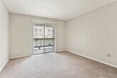 This single-floor, 2-bedroom, 3-bathroom residence in Gardendale, Alabama offers a thoughtfully organized layout with a neutral, warm color palette throughout. The living room is bright and inviting, featuring soft carpeted flooring and a sliding glass door dressed with vertical blinds that fills the space with natural light and provides outdoor views. The kitchen is efficiently designed with white shaker-style cabinetry, marble-look countertops, tile flooring, and stainless steel appliances including a refrigerator and dishwasher, complemented by a peninsula that opens toward the main living area. A hallway connects the bedrooms and bathrooms, maintaining a clean flow through the home. The primary bedroom offers comfortable proportions with plush carpet and direct access to a dedicated walk-in closet featuring built-in shelving. The second bedroom also features carpeted flooring, a window with natural light, and a closet. All three bathrooms are finished with tile flooring and marble-look countertops, each including a shower/tub combination. Additional highlights include a dedicated laundry area, a textured ceiling throughout, and soft, neutral wall tones that create a cohesive and calming ambiance across all rooms.