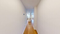 Located on the 7th floor of a well-established mid-rise building in Toronto's prestigious Avenue Road corridor, this one-bedroom, one-bathroom suite offers a thoughtfully updated interior within a compact, efficiently designed layout. Warm hardwood-style flooring flows consistently throughout the unit, providing a cohesive and inviting aesthetic.

The kitchen is a standout feature, extensively renovated with crisp white shaker cabinetry extending to ceiling height for maximum storage, stone-look countertops, stainless steel appliances including a built-in range, dishwasher, refrigerator, and microwave, plus a central island with an undermount sink — an ideal setup for both everyday cooking and entertaining. Recessed lighting and multiple windows fill the kitchen and living area with natural light and views of the surrounding cityscape.

The bedroom is a well-proportioned, quiet retreat featuring a sliding-door closet, a built-in bookshelf, and a window overlooking the urban neighbourhood. The bathroom is clean and modern, finished with white subway tile surrounding a full soaker tub. A private balcony extends the living space outdoors, offering open views of the tree-lined streets and neighbouring mid-rise buildings. The building's classic brick facade and green surroundings complete this urban Toronto address.