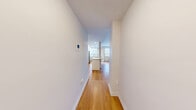 Located on the 7th floor of a well-established mid-rise building in Toronto's prestigious Avenue Road corridor, this one-bedroom, one-bathroom suite offers a thoughtfully updated interior within a compact, efficiently designed layout. Warm hardwood-style flooring flows consistently throughout the unit, providing a cohesive and inviting aesthetic.

The kitchen is a standout feature, extensively renovated with crisp white shaker cabinetry extending to ceiling height for maximum storage, stone-look countertops, stainless steel appliances including a built-in range, dishwasher, refrigerator, and microwave, plus a central island with an undermount sink — an ideal setup for both everyday cooking and entertaining. Recessed lighting and multiple windows fill the kitchen and living area with natural light and views of the surrounding cityscape.

The bedroom is a well-proportioned, quiet retreat featuring a sliding-door closet, a built-in bookshelf, and a window overlooking the urban neighbourhood. The bathroom is clean and modern, finished with white subway tile surrounding a full soaker tub. A private balcony extends the living space outdoors, offering open views of the tree-lined streets and neighbouring mid-rise buildings. The building's classic brick facade and green surroundings complete this urban Toronto address.