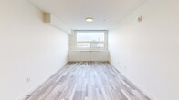 Located at 1800 4th St SW in Calgary's vibrant Mission neighbourhood, this thoughtfully designed one-bedroom, one-bathroom unit offers a efficient and modern living experience. Light-toned laminate flooring flows throughout, complementing the bright, neutral palette that defines the space.

The open-concept kitchen and living area serves as the heart of the unit. The kitchen features warm natural wood cabinetry extending to the ceiling, sleek white quartz countertops, a peninsula with a double undermount sink, and a full suite of stainless steel appliances including a refrigerator, electric range, and built-in microwave.

The bedroom is a calm, light-filled retreat with a large window framing views of the Calgary skyline. Built-in low cabinetry beneath the window provides additional storage, while a set of sliding panel doors conceals a generous closet.

The bathroom is finished with wood-grain tile flooring, a natural wood vanity with an undermount sink, a backlit mirror, and marble-look tile surrounding the tub and shower. A dedicated in-suite laundry area with a stacked washer and dryer adds everyday convenience. Clean lines and contemporary finishes make this a polished and functional urban home.