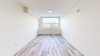 Located at 1800 4th St SW in Calgary's vibrant Mission neighbourhood, this thoughtfully designed one-bedroom, one-bathroom unit offers a efficient and modern living experience. Light-toned laminate flooring flows throughout, complementing the bright, neutral palette that defines the space.

The open-concept kitchen and living area serves as the heart of the unit. The kitchen features warm natural wood cabinetry extending to the ceiling, sleek white quartz countertops, a peninsula with a double undermount sink, and a full suite of stainless steel appliances including a refrigerator, electric range, and built-in microwave.

The bedroom is a calm, light-filled retreat with a large window framing views of the Calgary skyline. Built-in low cabinetry beneath the window provides additional storage, while a set of sliding panel doors conceals a generous closet.

The bathroom is finished with wood-grain tile flooring, a natural wood vanity with an undermount sink, a backlit mirror, and marble-look tile surrounding the tub and shower. A dedicated in-suite laundry area with a stacked washer and dryer adds everyday convenience. Clean lines and contemporary finishes make this a polished and functional urban home.