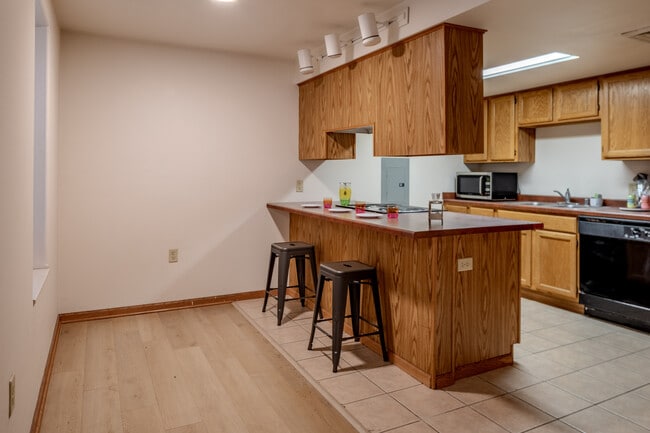 Kitchen and Breakfast Bar - Collegiate Campus Apartments