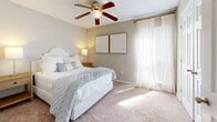 This 2-bedroom, 2-bathroom apartment at Lakeshore Pointe in Brandon, Mississippi offers a thoughtfully designed single-floor layout with a neutral color palette and quality finishes throughout. The living room serves as the heart of the home, featuring rich hardwood flooring, a classic fireplace flanked by large windows that invite natural light, a textured ceiling, and a ceiling fan for year-round comfort. The open flow connects seamlessly to a dining area, making the space well-suited for both everyday living and entertaining. The galley-style kitchen is equipped with rich dark cabinetry, granite countertops, a tile backsplash, stainless steel appliances, and hardwood flooring, maximizing both storage and functionality. The primary bedroom offers plush carpeting, a ceiling fan, and a window with natural light, providing a comfortable retreat. The second bedroom mirrors this comfortable aesthetic with carpet, a ceiling fan, and ample space. Both bathrooms are finished with granite-topped dark wood vanities, hardwood floors, and tub-shower combinations. A connecting hallway ties all rooms together efficiently, completing this well-appointed and move-in-ready residence in Brandon, MS.