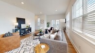 The Rowan model unit at 5178–5188 Hickory Hollow Pkwy in Nashville, Tennessee, is a three-floor residence that showcases a clean, contemporary design throughout. The layout is thoughtfully organized across its levels, offering a variety of functional spaces finished with consistent, modern detailing.

The main living area is bright and open, featuring light hardwood flooring, recessed lighting, and multiple windows that invite natural light. French doors provide an additional connection to the outdoors, enhancing the airy atmosphere. The kitchen is well-appointed with gray shaker-style cabinetry, white quartz countertops, a classic subway tile backsplash, stainless steel appliances including a range with a wall-mounted hood, and a central island that supports both meal preparation and casual dining.

The bathrooms maintain a clean aesthetic, with warm hardwood-style flooring, white fixtures, and chrome hardware. A powder room features a pedestal sink beneath an oval mirror, while additional bathrooms offer more utility-focused layouts. Bedrooms are carpeted in neutral tones, providing a comfortable feel, and include closet storage. A flexible room with carpet and a window serves well as a home office or secondary bedroom. The attached garage offers generous space with concrete flooring and an automatic opener.