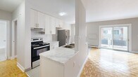 This 49 square meter apartment in Oshawa offers a thoughtful blend of comfort and efficiency. The single-floor layout comprises one bedroom, one bathroom, and a well-appointed kitchen. The primary bedroom, measuring 13 square meters, provides ample space for rest and relaxation.

The kitchen is a standout feature, boasting modern white cabinetry, stainless steel appliances, and a sleek marble countertop that doubles as a breakfast bar. The open concept design seamlessly connects the kitchen to the living area, creating a spacious feel.

Throughout the apartment, warm parquet flooring adds character and warmth. Large windows in the living area and bedroom flood the space with natural light and offer views of the surrounding cityscape. The bathroom features clean, white tile work and a practical shower-tub combination.

The apartment's neutral color palette, predominantly whites and light grays, creates a bright and airy ambiance. Baseboard heating ensures comfort year-round. Located at 296 Grenfell St, this apartment combines modern amenities with a convenient urban setting, making it an ideal residence for singles or couples seeking a contemporary living space in Oshawa.