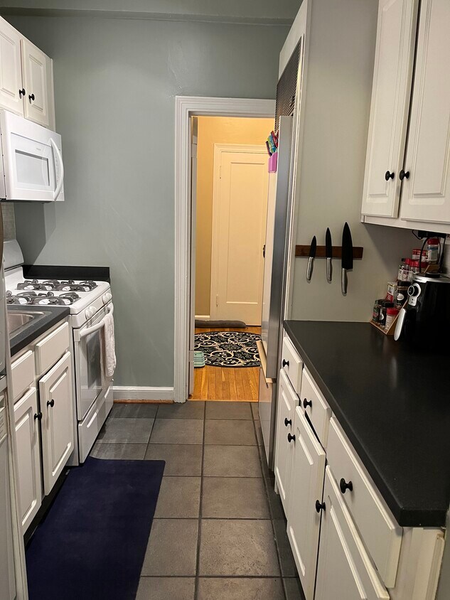 Kitchen with gas range, sun zero refrigerator and washer/dryer - 4007 Connecticut Ave NW