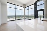 Located in the heart of Boise, ID, this modern single-floor residence offers four bedrooms, three bathrooms, and a thoughtfully designed layout that maximizes both comfort and style. Light-toned hardwood flooring flows seamlessly throughout, complementing the clean white walls and minimalist aesthetic that define the space.

The living area is a true standout, featuring dramatic floor-to-ceiling glass windows that wrap around the corner, flooding the room with natural light and framing breathtaking panoramic views of the Boise cityscape and the rolling foothills beyond. The kitchen is well-appointed with light wood cabinetry, white quartz countertops, a gas range, stainless steel appliances including a French door refrigerator, and a functional galley-style layout.

The primary bathroom is a luxurious retreat, showcasing a freestanding soaking tub, a glass-enclosed walk-in shower with full tile surround, a light wood double vanity, and large-format tile flooring. Additional bathrooms maintain the same refined aesthetic with wood-toned cabinetry and illuminated mirrors. Bedrooms are generously proportioned, with select rooms enjoying the same stunning floor-to-ceiling views. The home also includes a patio, a dedicated laundry area, and four closets, rounding out a well-organized and refined urban residence.