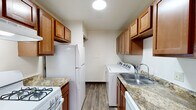 Located at 2483 Bow Ct in South Bend, Indiana, this single-floor unit offers a well-organized and functional layout designed for comfortable everyday living. The entryway opens into a bright living area featuring a combination of plush carpeting and wood-look vinyl flooring, with a ceiling fan overhead and a large window fitted with vertical blinds that allow ample natural light to flow in.

The galley-style kitchen is efficiently designed, offering warm-toned wood cabinetry, granite-look countertops, and white appliances including a gas range and refrigerator. A standout feature is the in-unit washer and dryer tucked conveniently within the kitchen space, providing added practicality. The kitchen flows seamlessly into the living area, making the space feel connected and open.

The bedrooms are generously sized, carpeted for comfort, and include closet storage with bifold doors and hanging rods. Natural light enters through windows with blinds, keeping each room bright and airy.

The unit includes two bathrooms. The full bathroom features a white vanity with cabinet storage, a mirror with overhead lighting, a full tub-and-shower combo, and wood-look vinyl flooring. The half bath is clean and simply appointed with a white vanity and matching fixtures. Together, these spaces provide a practical and comfortable living environment.