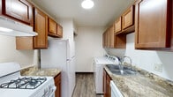 Located at 2483 Bow Ct in South Bend, Indiana, this single-floor unit offers a well-organized and functional layout designed for comfortable everyday living. The entryway opens into a bright living area featuring a combination of plush carpeting and wood-look vinyl flooring, with a ceiling fan overhead and a large window fitted with vertical blinds that allow ample natural light to flow in.

The galley-style kitchen is efficiently designed, offering warm-toned wood cabinetry, granite-look countertops, and white appliances including a gas range and refrigerator. A standout feature is the in-unit washer and dryer tucked conveniently within the kitchen space, providing added practicality. The kitchen flows seamlessly into the living area, making the space feel connected and open.

The bedrooms are generously sized, carpeted for comfort, and include closet storage with bifold doors and hanging rods. Natural light enters through windows with blinds, keeping each room bright and airy.

The unit includes two bathrooms. The full bathroom features a white vanity with cabinet storage, a mirror with overhead lighting, a full tub-and-shower combo, and wood-look vinyl flooring. The half bath is clean and simply appointed with a white vanity and matching fixtures. Together, these spaces provide a practical and comfortable living environment.
