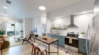 Located at 403 N First St in Rogers, Arkansas, this thoughtfully designed one-bedroom, one-bathroom unit offers a cohesive modern aesthetic across its single-floor layout. The open-concept kitchen and living area serves as the heart of the space, where sage-green cabinetry pairs with white tile backsplash, granite-look countertops, and a full suite of stainless steel appliances, including a gas range, dishwasher, and refrigerator. A stainless wall-mounted range hood adds an industrial touch, while a built-in peninsula with bar seating provides a functional dining area. Light wood flooring flows throughout, enhancing the bright, airy atmosphere created by white walls and recessed lighting. The living area is generously proportioned, featuring a sliding glass door that opens to a private outdoor space, flooding the room with natural light. The bedroom is a calm retreat with a large window, a walk-in closet with barn-style sliding doors, and ample room for a full furniture arrangement. The bathroom continues the green cabinetry theme with a granite-top vanity, large mirror, and a shower/tub combination, all set on herringbone-patterned wood-look flooring. Clean lines and contemporary finishes define this well-appointed Rogers residence.