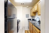 Located at 852 Barnaby St SE in Washington, DC, this single-floor, three-bedroom, two-bathroom residence offers a functional and well-organized layout. The entrance leads into a hallway that connects the main living areas, creating a logical flow throughout the home.

The galley-style kitchen is outfitted with warm honey-toned wood cabinetry, dark granite-style countertops, and stainless steel appliances including a refrigerator, gas range, and dishwasher — all set atop light wood-style flooring. An adjacent dining room provides a dedicated space for meals.

The living room is bright and open, featuring large windows that invite natural light and offer views of the surrounding greenery. Light-toned hardwood-style flooring runs through the main living areas, contributing to a clean, cohesive aesthetic.

All three bedrooms are carpeted for comfort, with neutral walls and windows providing natural light. The primary bedroom includes a walk-in closet, while the additional bedrooms feature their own closet spaces — five closets in total throughout the home. 

The two bathrooms are finished with wood-toned vanities and light flooring. One bathroom includes a full tub-shower combination, while the other serves as a half bath with a single vanity and toilet.
