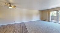 Located at 2366 American River Dr in Sacramento, CA, this single-floor residence offers a well-organized layout with two bedrooms, two bathrooms, a combined kitchen and living area, a hallway, and a dedicated closet. The open living room is a welcoming focal point, featuring a classic fireplace with dark glass doors, plush carpet flooring, and neutral warm-toned walls that create a calm, comfortable atmosphere. A ceiling fan overhead adds functionality, and the space transitions seamlessly into the dining and kitchen area via wood-look vinyl flooring. The kitchen is equipped with light wood cabinetry, light-toned countertops, white appliances, and a pass-through bar that connects it to the living space. A window allows natural light to brighten the kitchen. Both bedrooms feature soft carpet, ceiling fans with integrated lighting, and windows that invite natural light and outdoor views. The primary bedroom is generously sized with a sliding closet. The two bathrooms are finished with light wood vanity cabinetry, light countertops, and clean white fixtures — one featuring a full tub-shower combo. Wood-look vinyl flooring runs through the bathrooms and hallway, tying the space together with a cohesive, practical design throughout.