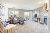 Located at 8550 Greenway Blvd in Middleton, WI, this well-appointed single-floor residence offers three bedrooms and two bathrooms within a thoughtfully designed layout. The entrance makes an immediate impression with a decorative arched colonnade framed by white columns, leading into a carpeted living room filled with natural light from large windows and a sliding glass door that opens to a private balcony. The adjacent dining room features a stylish pendant light fixture and neutral gray walls, creating an inviting space for entertaining. The kitchen is equipped with rich wood-toned cabinetry, granite-style countertops, stainless steel appliances, and durable hardwood-style flooring, combining both form and function. The primary bedroom offers a comfortable retreat with a bold accent wall, carpeted flooring, and a window with outdoor views. The two bathrooms are finished with white vanities, tile flooring, and clean, modern fixtures — one featuring a walk-in shower and the other with a bathtub. Carpeted hallways connect the bedrooms, which are serviced by two closets. The overall aesthetic is cohesive and neutral, with soft tones and consistent finishes throughout, creating a calm and functional living environment.