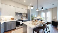 This 530 square foot, one-bedroom apartment in Austin, TX showcases a modern and efficient design. The open-concept layout seamlessly blends the living room, kitchen, and dining area, creating a spacious feel despite the compact footprint. The living room features a comfortable sofa, stylish coffee table, and direct access to a balcony through floor-to-ceiling glass doors, flooding the space with natural light.

The kitchen boasts contemporary finishes with two-tone cabinetry, stainless steel appliances, and a large island with seating, perfect for casual dining or entertaining. Pendant lighting adds a touch of elegance to the space.

The 110 square foot bedroom offers ample space for a queen-sized bed and includes large windows for natural light. A sleek dresser and round mirror complete the room's modern aesthetic. The bathroom features a glass-enclosed shower, modern vanity, and continues the apartment's cohesive design with matching wood-look flooring.

Throughout the apartment, neutral tones and natural textures create a calming atmosphere, while strategic lighting enhances the overall ambiance. The clever use of space and thoughtful design elements make this compact apartment feel much larger than its square footage suggests.