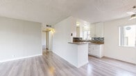 Located in Pasadena, CA, this single-floor, 3-bedroom, 2-bathroom home offers a thoughtfully arranged layout that makes efficient use of its space. Light-toned laminate flooring runs throughout the home, providing a clean, cohesive look. The living room is a bright, open area featuring sliding glass doors that lead directly to a private patio, allowing natural light to fill the space and offering views of the surrounding greenery. Adjacent to the living room, a dedicated dining area provides a natural flow for everyday living. The kitchen is a standout feature, equipped with white shaker cabinetry, granite-look countertops, a mosaic tile backsplash, stainless steel appliances, and a peninsula that opens toward the living and dining areas. A window above the sink brings in additional natural light. The three bedrooms are comfortably sized — the primary bedroom includes a mirrored sliding closet. Each bedroom benefits from windows that invite natural light. The two bathrooms are clean and functional, one featuring a glass-enclosed shower. A dedicated laundry area adds convenience, and three closets offer ample storage. Textured ceilings are present throughout. The patio provides an outdoor retreat, completing this well-appointed Pasadena home.