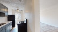 Located in the vibrant Koreatown neighborhood of Los Angeles, this single-floor unit at 437 N Ardmore Ave offers a thoughtfully updated interior with a clean, functional layout. Light wood flooring runs throughout, lending warmth and continuity to the space.

The kitchen is a standout feature, equipped with gray shaker-style cabinetry, white countertops, a stainless steel undermount sink with a modern pull-down faucet, and black appliances including a gas range and refrigerator. A decorative textured ceiling with a ceiling fan adds character to the kitchen area, while a multi-pane window allows natural light to filter in.

The living area is open and airy, benefiting from recessed lighting and generous natural light that pours in through large windows, highlighting the clean white walls and wood floors. Multiple rooms serve well as bedrooms, each featuring light-filled windows with classic multi-pane detailing, recessed lighting, and ample wall space. One bedroom includes a closet with built-in shelving, offering practical storage.

The bathroom is clean and straightforward, with a white vanity, mirror, and essential fixtures. A bathtub is also present, as visible in the floorplan overview. The unit's neutral palette and updated finishes throughout create a bright, move-in-ready environment.