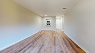 Located at 93 Richards Ave in Norwalk, CT, this well-appointed 2-bedroom, 2-bathroom residence offers a comfortable and functional single-floor layout. Warm hardwood-style flooring flows consistently throughout the space, lending a cohesive and clean aesthetic to every room.

The open living and dining area is bathed in natural light, courtesy of a sliding glass door that opens to a private balcony overlooking lush greenery. The galley-style kitchen is outfitted with white shaker cabinetry, light countertops, a stainless steel sink, and a full suite of stainless steel appliances including a refrigerator, dishwasher, and range — complemented by a convenient pass-through window to the living area.

The spacious primary bedroom features its own sliding door access to outdoor views and generous closet storage. The second bedroom is bright and airy, with a large window framing natural light. Three closets throughout the unit — including a well-organized walk-in with wire shelving — offer ample storage. Both bathrooms are clean and functional: one with a full soaking tub and built-in shelving, and the other with a walk-in shower, vanity, and modern hardware. An in-unit laundry area adds everyday convenience to this thoughtfully designed residence.