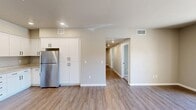 Located at 800 W Battles Rd in Santa Maria, California, this single-story residence offers three bedrooms and three bathrooms within a thoughtfully designed floor plan. The interior features a clean, contemporary aesthetic with neutral tones, luxury vinyl plank flooring in the main living areas, and plush carpeting in the bedrooms.

The kitchen is a standout feature, offering an abundance of white shaker cabinetry with matte black hardware, granite-look countertops, stainless steel appliances including a refrigerator, electric range with microwave, and dishwasher, as well as a dedicated pantry for additional storage. Recessed lighting illuminates the space efficiently.

Each bathroom is finished with tile flooring, white vanity cabinetry, granite-look countertops, and large mirrors. The bathrooms include shower and tub configurations suited for everyday convenience. The bedrooms are generously sized, with the primary bedroom offering ample closet space. A total of four closets are distributed throughout the unit, complemented by a dedicated laundry area.

The residence is part of a vibrant residential community featuring landscaped outdoor spaces, a children's playground, splash pad, and seating areas — all visible from the balcony, which offers open views of the well-maintained grounds under Santa Maria's characteristically sunny skies.