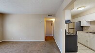 Located at 2975 Harrison St in Paducah, Kentucky, this one-bedroom, one-bathroom unit offers a practical and well-organized single-floor layout. The living room features neutral-toned carpet and a window that allows natural light to filter in, creating a bright and open feel. An adjoining hallway connects the main living area to the rest of the unit, providing a logical and efficient flow throughout.

The galley-style kitchen is thoughtfully designed with white cabinetry lining both walls, light tile flooring, a stainless steel sink, an electric range, and a full-size refrigerator, offering ample storage and workspace for everyday cooking needs.

The bedroom is a comfortable, well-proportioned space finished with soft carpeting and a window overlooking the outdoors, providing natural light and ventilation. A closet is conveniently located within the room. The full bathroom includes a tiled shower and tub combination with chrome fixtures, providing a clean and functional space.

Neutral beige tones carry throughout the unit, lending a cohesive and understated aesthetic. Light tile flooring in the entry and kitchen transitions smoothly to carpet in the living and sleeping areas. This unit is a straightforward and functional home well-suited for those seeking a manageable, low-maintenance living space in Paducah.