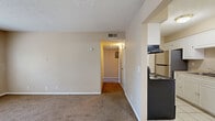 Located at 2975 Harrison St in Paducah, Kentucky, this one-bedroom, one-bathroom unit offers a practical and well-organized single-floor layout. The living room features neutral-toned carpet and a window that allows natural light to filter in, creating a bright and open feel. An adjoining hallway connects the main living area to the rest of the unit, providing a logical and efficient flow throughout.

The galley-style kitchen is thoughtfully designed with white cabinetry lining both walls, light tile flooring, a stainless steel sink, an electric range, and a full-size refrigerator, offering ample storage and workspace for everyday cooking needs.

The bedroom is a comfortable, well-proportioned space finished with soft carpeting and a window overlooking the outdoors, providing natural light and ventilation. A closet is conveniently located within the room. The full bathroom includes a tiled shower and tub combination with chrome fixtures, providing a clean and functional space.

Neutral beige tones carry throughout the unit, lending a cohesive and understated aesthetic. Light tile flooring in the entry and kitchen transitions smoothly to carpet in the living and sleeping areas. This unit is a straightforward and functional home well-suited for those seeking a manageable, low-maintenance living space in Paducah.