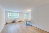 Located at 420 Morris Road in Wayne, PA, this well-appointed 2-bedroom, 1-bathroom residence offers a thoughtfully designed single-floor layout. The galley-style kitchen is a standout feature, showcasing stainless steel appliances, two-toned cabinetry with light wood and white finishes, a hexagonal tile backsplash, and bright light wood flooring — all illuminated by a skylight overhead. The open living and dining area is bathed in natural light from multiple large windows offering lush green views, and features the same warm hardwood-style flooring that extends throughout the common areas. A built-in breakfast bar provides a convenient dining option adjacent to the kitchen. Both bedrooms are comfortably sized and feature plush wall-to-wall carpeting, individual wall AC units, and large windows that frame outdoor greenery. The primary bedroom offers generous dimensions with ample room to furnish. The full bathroom is finished with neutral large-format tile in the tub-shower surround, tile flooring, and a clean white vanity. The unit also includes five closets for exceptional storage, a dedicated laundry area, and an entrance hallway. Clean white walls and consistent finishes throughout create a bright, cohesive aesthetic.